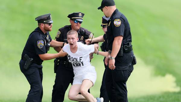 Protesters storm 18th green, delay finish of Travelers Championship