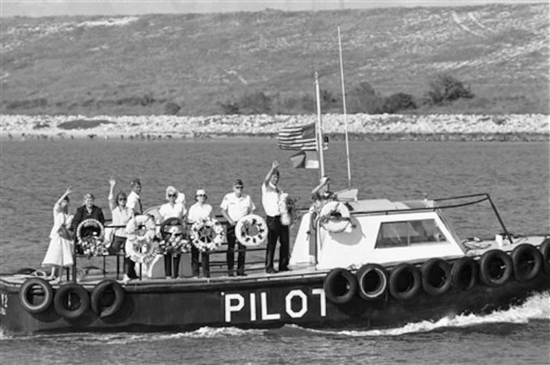 A delegation from the Veterans of Foreign Wars, Post 10131, Cape Canaveral, Florida carrying seven wreaths, ride a boat into the Atlantic ocean, Monday, Feb. 3, 1986 to drop the wreaths in honor of the seven crew members killed in the explosion of the Space Shuttle Challenger. (AP Photo/Terry Renna)