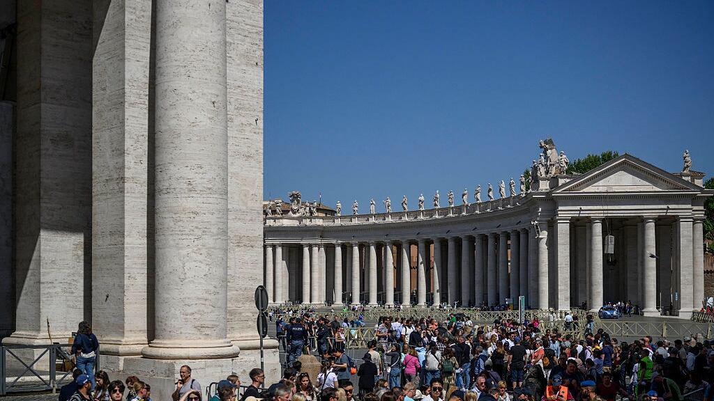People gather outside of the Vatican.