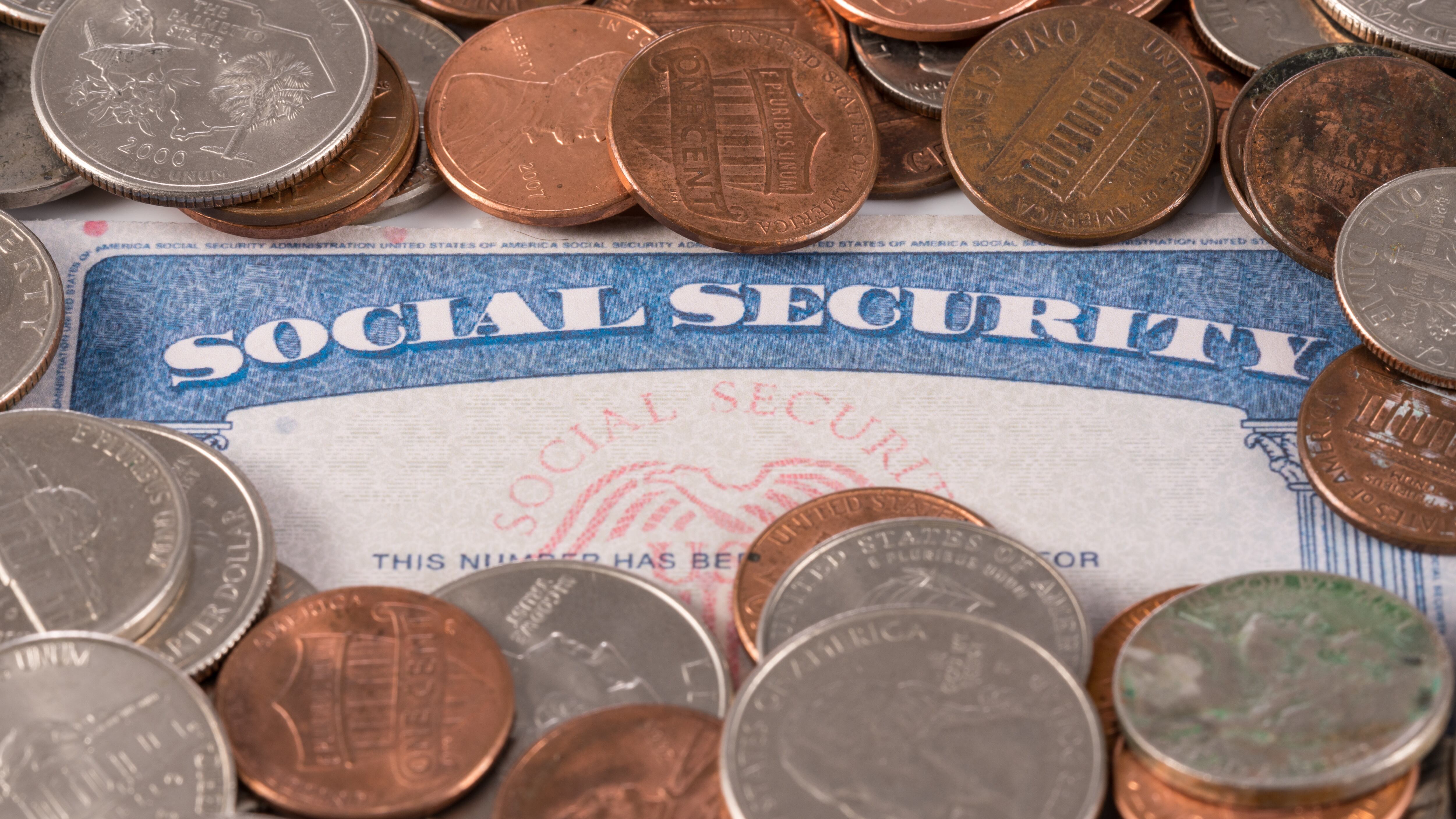 USA social security card with coins and cash