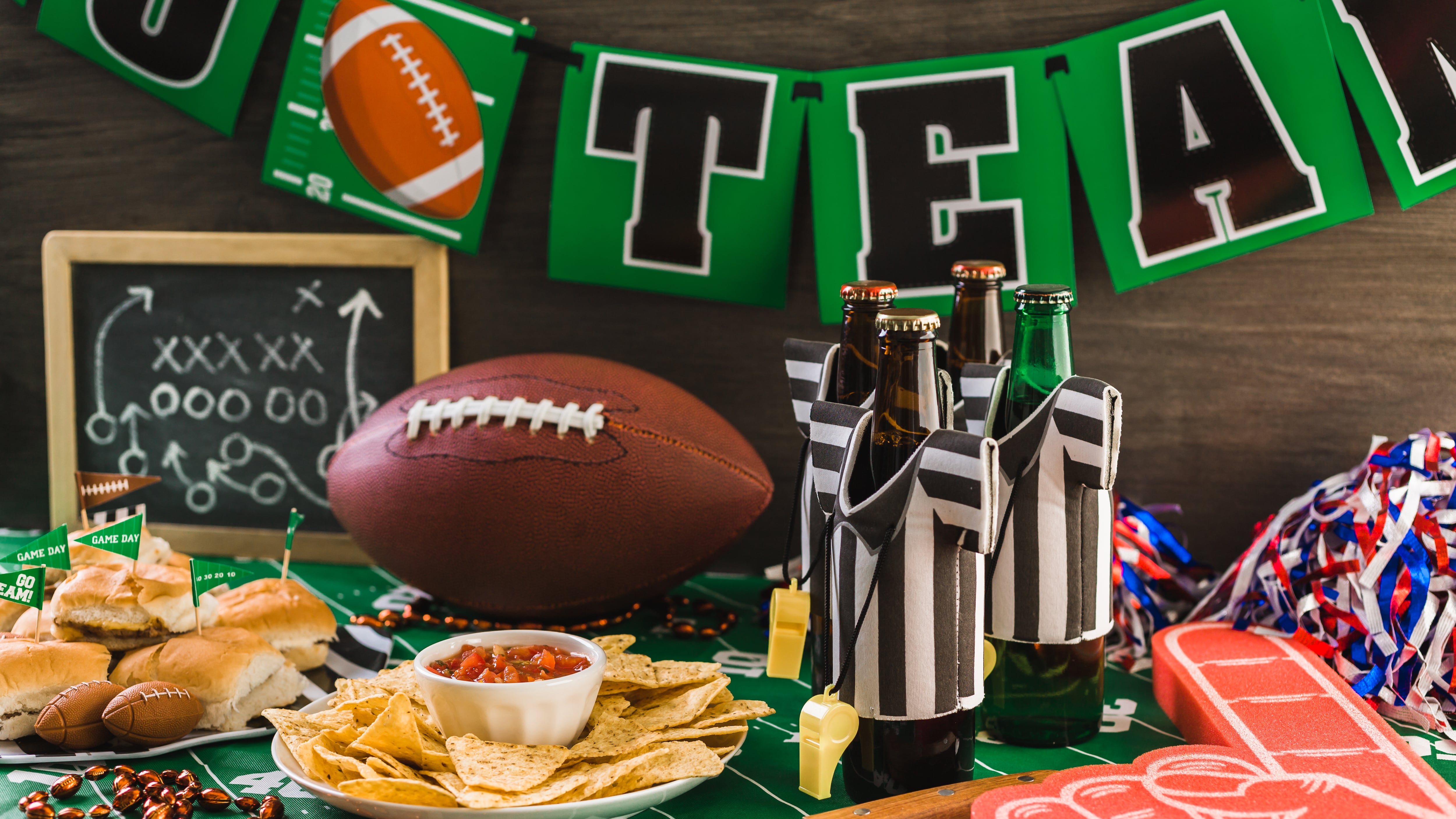 Game day football party table with beer, chips and salsa.